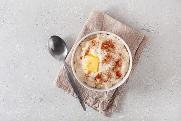 rice pudding with butter cinnamon. french riz au lait, norwegian risgrot, traditional breakfast dessert