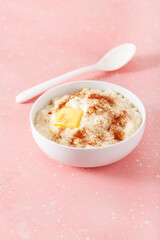 rice pudding with butter cinnamon. french riz au lait, norwegian risgrot, traditional breakfast dessert