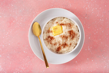 rice pudding with butter cinnamon. french riz au lait, norwegian risgrot, traditional breakfast dessert