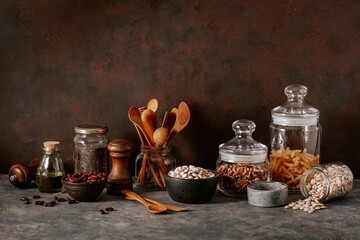 Obraz na płótnie Canvas kitchen utensils on modern simple counter, kitchenware jars with dry ingredients bowls
