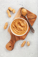 smooth peanut butter in bowl on gray background