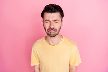 Photo of disappointed depressed unhappy guy with brunet hairstyle yellow t-shirt crying eyes closed...