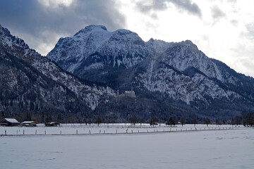 picturesque wintery bavarian countryside Schwangau in the alpine valley surrounded by the scenic Bavarian Alps on a snowy December day (Bavaria, Germany)