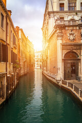 View of the street canal in Venice, Italy. Colorful facades of old Venice houses. Venice is a popular tourist destination of Europe. Venice, Italy.