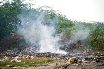 Garbage Dumping and burning site creating air pollution by smoke, pollution control day, land pollution, Raipur, india, Pollution concept