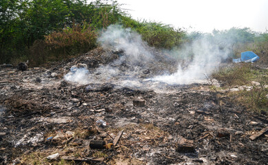 Garbage Dumping and burning site creating air pollution by smoke, pollution control day, land pollution, Raipur, india