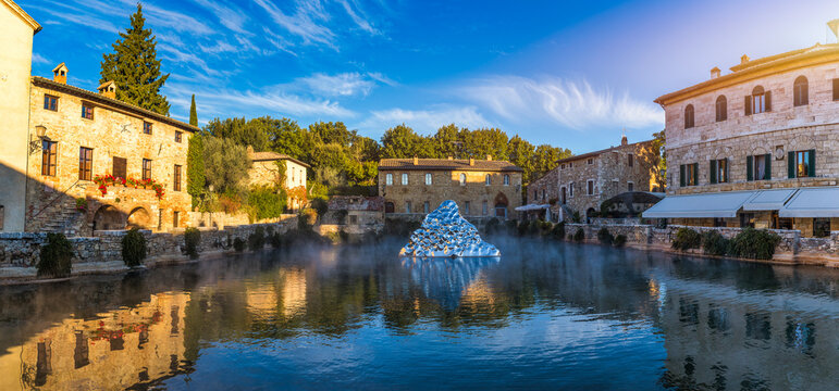 Thermal bath town of Bagno Vignoni, Italy during sunrise. Old thermal baths in the medieval village Bagno Vignoni, Tuscany, Italy. Medieval thermal baths in village Bagno Vignoni, Tuscany, Italy