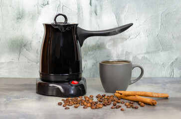 Electric coffee maker for making Turkish coffee. coffee pot, cup, coffee beans and cinnamon sticks