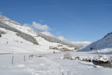 Fototapeta na wymiar Austrian village under snow on a sunny, winter day