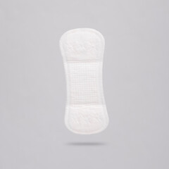Women's sanitary pad levitating on gray background with a shadow. Feminine hygiene