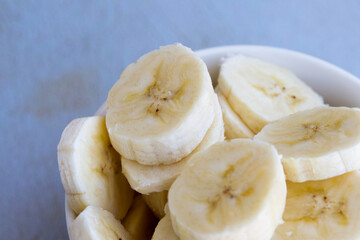Sliced bananas in macro photography. Concept of healthy food and fruits.