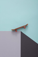 Toy skateboard on a paper cube. Optical illusion. Geometric composition. Minimalistic creative layout © splitov27