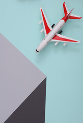 Toy air plane with paper cube. Optical illusion. Geometric composition. Minimalistic creative layout
