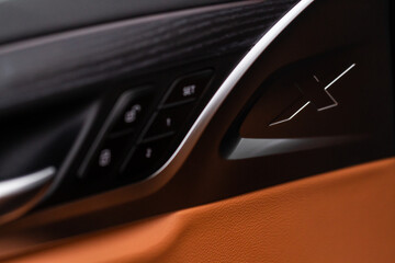 Modern car interior door handle close up. Metallic Car door opener handle inside.