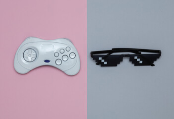 Pixelated 8 bit sunglasses with gamepad on pastel background