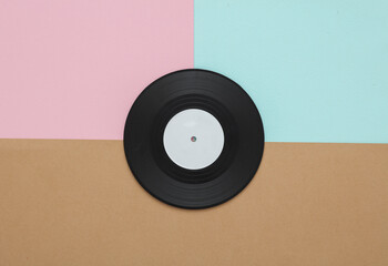 Vinyl record on colored background. Top view