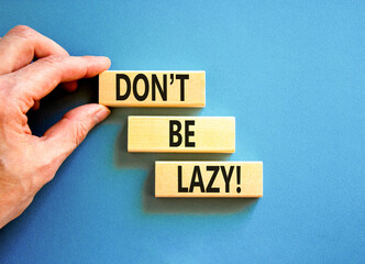 Motivational and do not be lazy symbol. Concept words Do not be lazy on wooden blocks on a beautiful blue table blue background. Businessman hand. Business do not be lazy concept. Copy space.