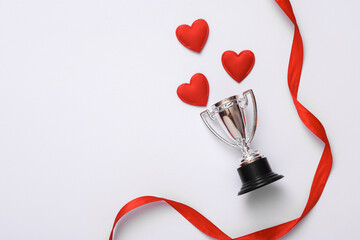 Winner cup with hearts on white background