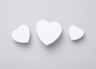 White heart shaped gift boxes mockup isolated on gray background. Top view