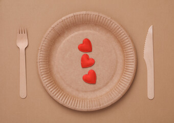 Craft plate with hearts on a brown background. Love concept