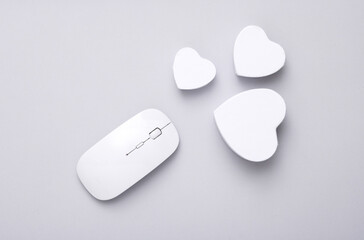 PC mouse with hearts in a box on a gray background. Layout for your design