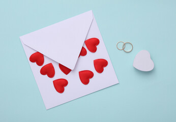 Golden ring with envelope and  hearts on blue background. Love concept, valentine's day, february 14th celebration, marriage proposal