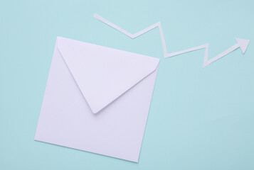 White envelope with a curved growth arrow on a blue background. Business concept