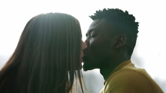 Young interracial couple kissing outside. Black man with white girlfriend kiss, diversity concept3