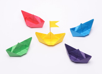 Paper colored boats on white background. Business, leadership concept