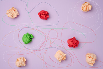 Crumpled paper balls and different paths. Concept of a strong leader with extraordinary thinking,...
