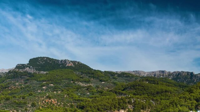 Aerial view of SOLLER,tourist town in the island of MAJORCA(MALLORCA in Spanish),with the movement of the clouds,the people and the traffic of the boats in its port.Time Lapse.Camera movement:Zoom out