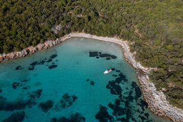 Aerial view of a small boat on the turquoise water of Mediterranean Sea