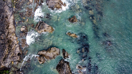 A lot of boulders in the sea. Coastal cliffs of the North Atlantic. Seaside beautiful nature. Dramatic seascape of the north of Europe. Aerial photo. View from above.