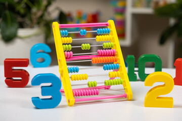 Colorful children's abacus on the table. Mathematics, arithmetic for preschool and school children, learning to count