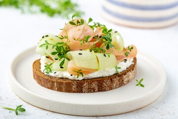 Healthy nutritious rye bread sandwich served on a white ceramic plate