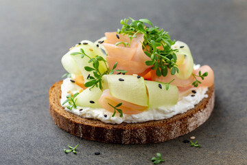 Healthy ham and cucumber open sandwich garnished with micro greens