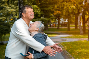 Obraz premium A funny happy couple, man hugs his beloved wife.