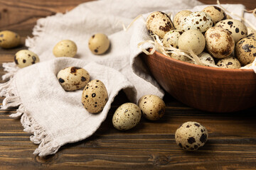 Quail eggs in a plate on a dark old brown wooden background. Eco product. Diet food. Healthy food. Space for text.Space for copy.