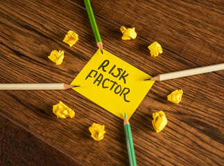 The inscription on paper Risk factor and pencils