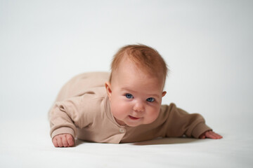 portrait of an infant looking into the camera on a white background