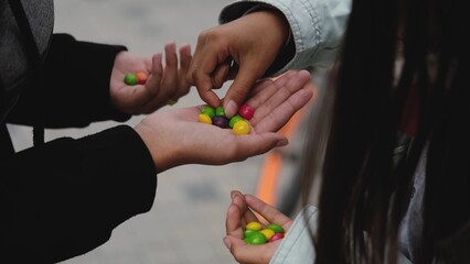 Close-up of colored candy or chewing gum. Children hold a bunch of colorful candies in their hands....