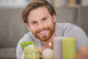 man is lighting candles for romance