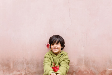 happy smiling girl with short hair against pink wall