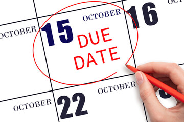 15th day of October. Hand writing text DUE DATE on calendar date October 15 and circling it....