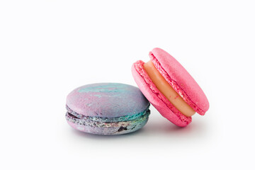 Obraz na płótnie Canvas Sweet colorful macarons isolated on white background. Tasty colourful macaroons. Two multi-colored blue and pink macaroons. French pastry made from egg whites.