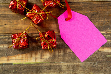 decorative christmas elements next to card with red ribbon and space to write