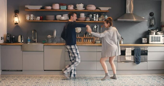 Happy, dance or couple in kitchen dancing in morning for freedom, fun or carefree weekend. Love, comic or man and woman dancer in house for comedy happiness, funny energy or crazy bonding together