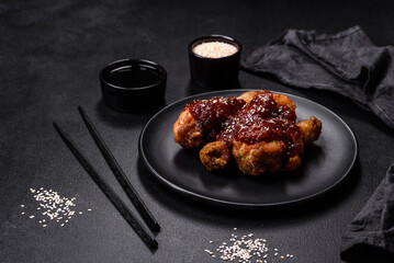 Tasty spicy chicken legs with teriyaki sauce and sesame seeds