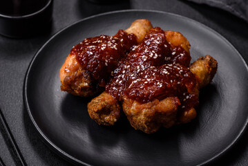 Tasty spicy chicken legs with teriyaki sauce and sesame seeds