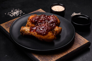 Tasty spicy chicken legs with teriyaki sauce and sesame seeds